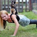 blonde woman, pet, animal, yorkie, dog, workout, push ups, smile