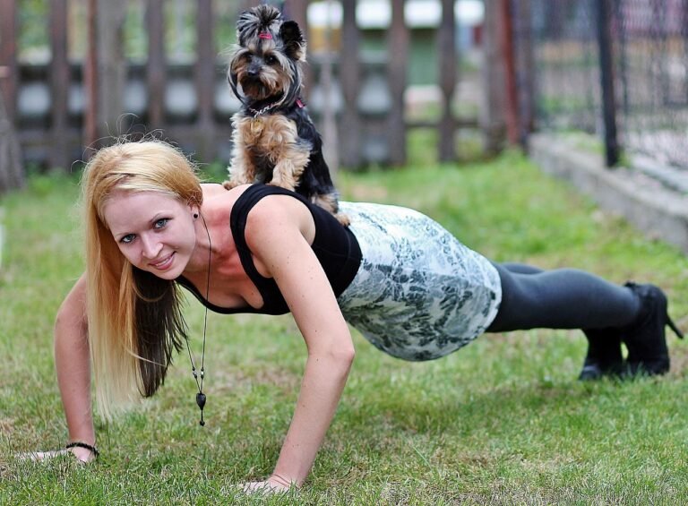 blonde woman, pet, animal, yorkie, dog, workout, push ups, smile